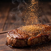 Hardcore Carnivore MeatyMite All-Purpose Rub — savoury umami rub sprinkled over a seared steak