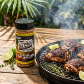 Elk Creek One Love Spice Island jerk rub — jerk chicken thighs charring over Caribbean charcoal