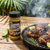 Elk Creek One Love Spice Island jerk rub — jerk chicken thighs charring over Caribbean charcoal
