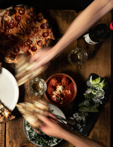 The Joy of Pizza by Dan Richer & Katie Parla hardback cookbook — table of Razza pizzas being shared