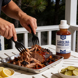 Pulling smoked pork shoulder dressed in Lillie's Q Carolina Barbeque Sauce