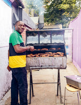 Live Fire by Helen Graves hardback cookbook — Jamaican jerk chicken feature with a cook at the grill