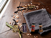 Low & Slow Brisket Box flat-lay — all 4 products on a rustic dark wood table
