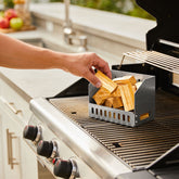 Natural Smoke Apple wood chunks being added to a smoker box on the BBQ