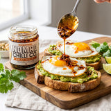 Nomad Chilli Co Salsa Macha chilli oil — crunchy chilli oil spooned over fried eggs on avocado toast