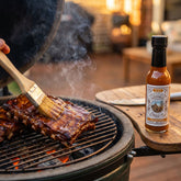 Nomad Chilli Co Tamarind Gold hot sauce — pork ribs glazed with tamarind on a kamado grill