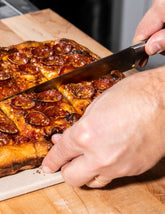 Pizza Czar by Anthony Falco hardback cookbook — Sicilian-style pepperoni pizza being sliced