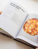Pizza Volume 01 by Gozney hardback cookbook — open spread of an upside-down cheese pizza recipe