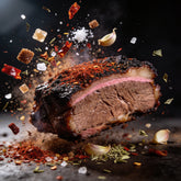 Plowboys Bovine Bold Rub ingredients exploding around a slice of smoked brisket with bark and smoke ring
