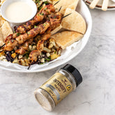 Rum and Que Intensify all purpose rub — chicken skewers with flatbread and dip, shaker alongside