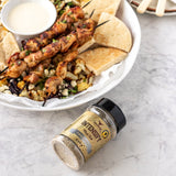 Rum and Que Intensify all purpose rub — chicken skewers with flatbread and dip, shaker alongside