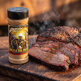 Heavenly Hell Diggers Dust beef rub 150g — shaker beside sliced smoked brisket with a dark peppery bark on a board