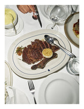 Steak House by Eric Wareheim & Gabe Ulla hardback cookbook — interior page of rib eye with roasted garlic