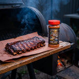Stef the Maori Pork Hunt pork and chicken seasoning — rack of sticky caramelised pork ribs resting by the smoker