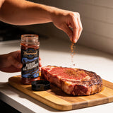 TAIPAN BBQ Aussie All-Rounder all-purpose BBQ rub 175g — use shot, hand sprinkling the rub onto a thick-cut steak