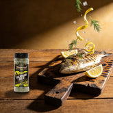 TAIPAN BBQ Galapagos Gold fish & seafood rub 125g — action shot, herb and lemon zest scattering over a grilled fish fillet