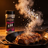 TAIPAN BBQ SPG steak & fish seasoning 300g — action shot, seasoning cloud freeze-frame over a searing steak