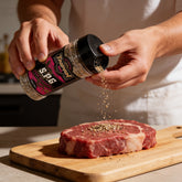 TAIPAN BBQ SPG steak & fish seasoning 300g — use shot, seasoning a raw steak on a board