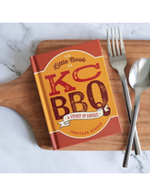 The Little Book of KC BBQ by Jonathan Bender hardback cookbook — mini hardback on a board with cutlery