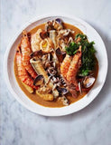 The Whole Fish Cookbook by Josh Niland hardback cookbook — interior page of a seafood stew with prepared fish and shellfish