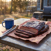 Tillman's Barbecue Competition Brew BBQ sauce — sliced smoked brisket with a dark glossy bark at dawn
