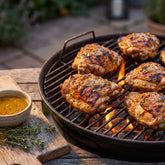 Tillman's Barbecue Florida Gold mustard BBQ sauce — grilled chicken thighs glazed golden on the charcoal grill