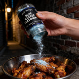Uncle Mungo's Blue Cheese Seasoning 300g blue cheese seasoning — shaking blue cheese seasoning over hot chicken wings