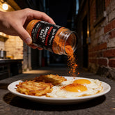 Uncle Mungo's Ghost Pepper Chicken Salt 300g ghost pepper chicken salt — shaking ghost pepper chicken salt over fried eggs and hash browns