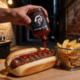 Uncle Mungo's Habanero Ketchup 200ml hot ketchup — squeezing habanero ketchup onto a grilled sausage roll with chips