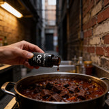 Uncle Mungo's OC Drops 10ml capsaicin extract — adding a single drop of OC Drops to a pot of beef chilli