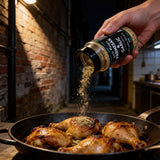 Uncle Mungo's Parmesan & Garlic 300g parmesan and garlic seasoning — shaking parmesan and garlic seasoning over roast chicken thighs