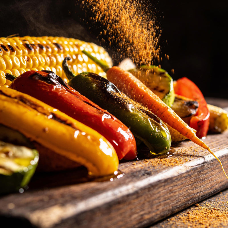 All-purpose seasoning falling over a grilled vegetable and corn weeknight spread - The Rub Hub Seasonings collection lifestyle photo