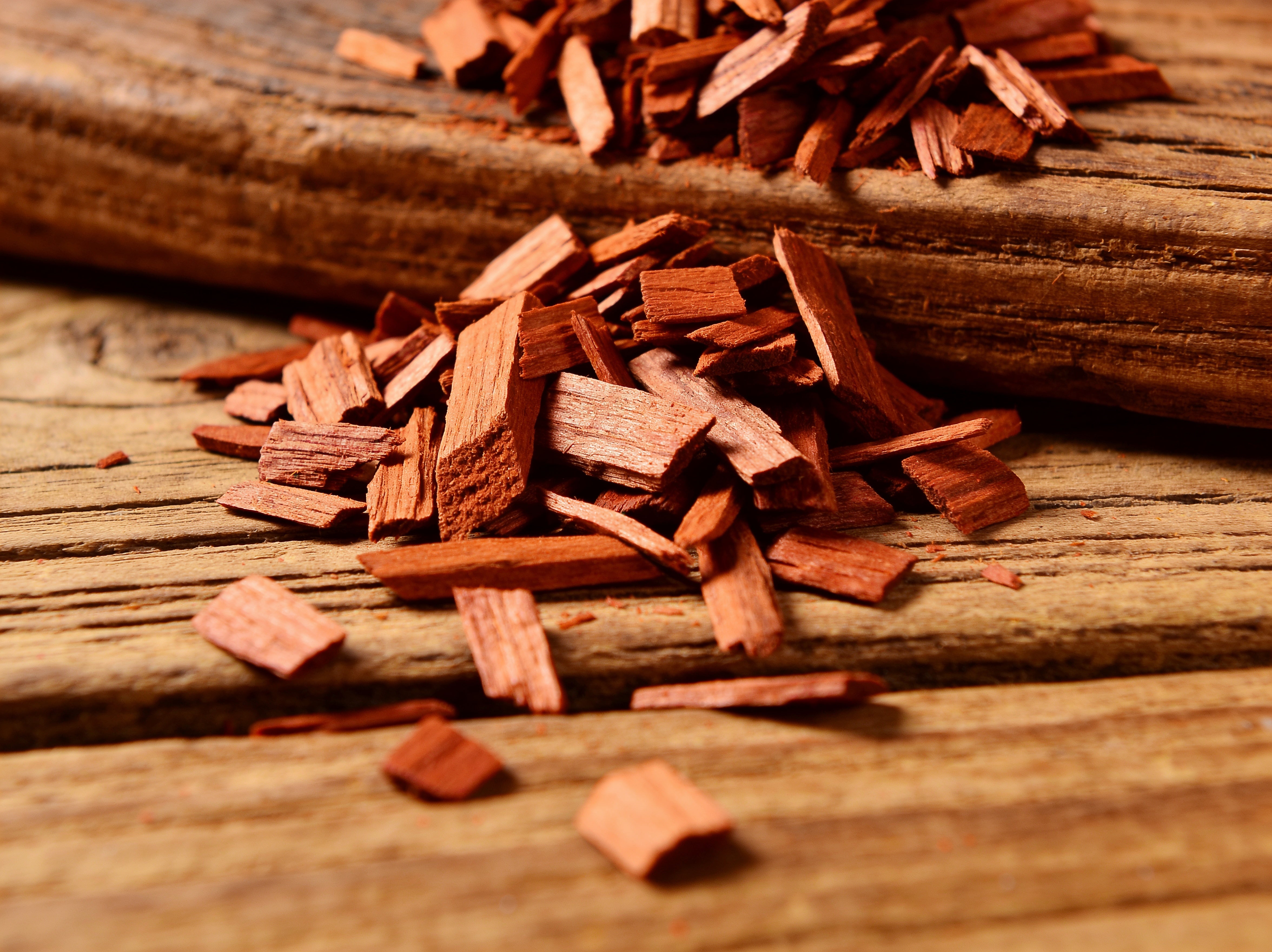 Western BBQ Products Cherry Smoking Wood Chips lifestyle photo — close-up beauty shot of raw cherry wood chips