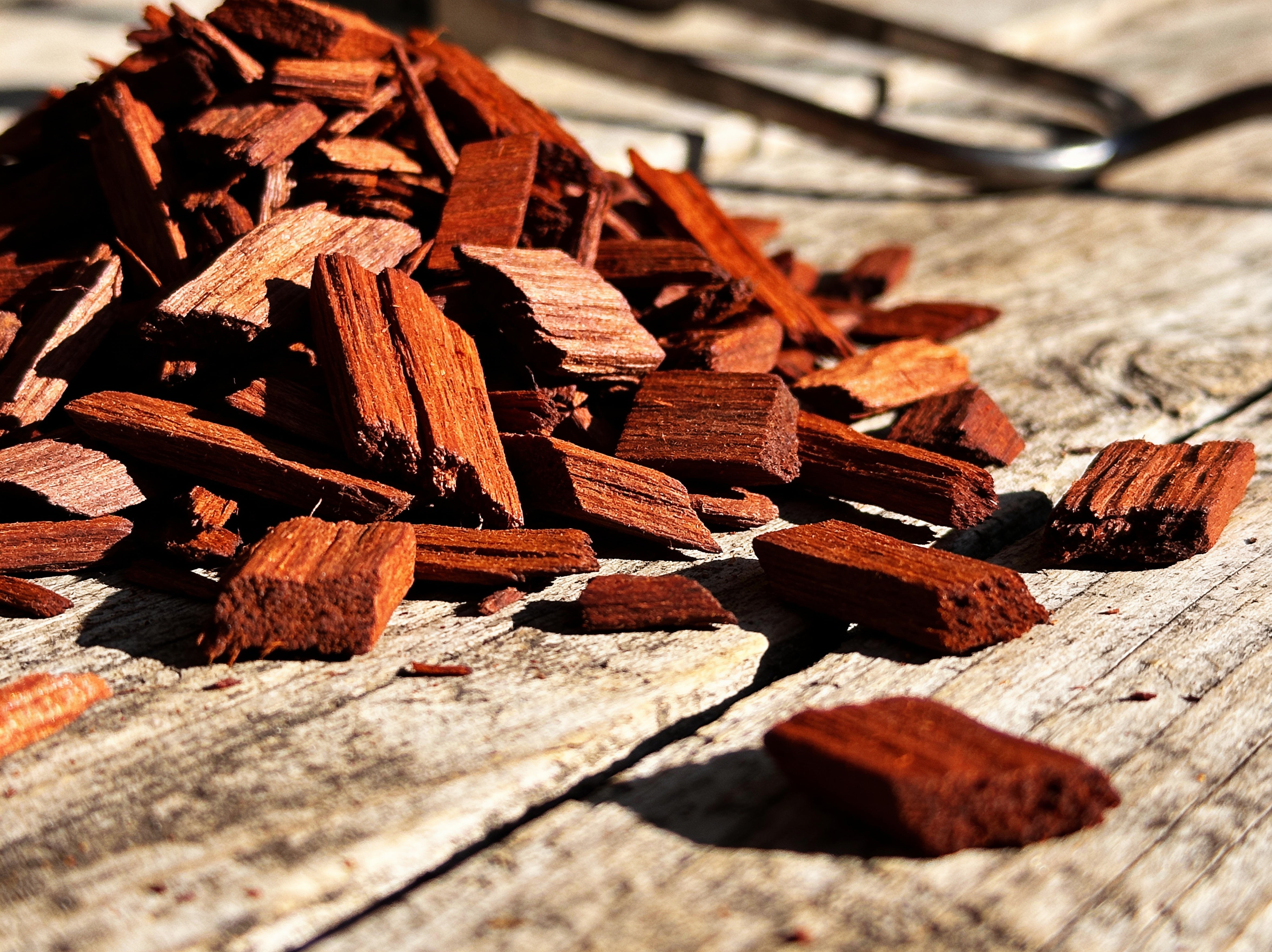 Western BBQ Products Mesquite Smoking Wood Chips lifestyle photo — close-up beauty shot of raw mesquite wood chips