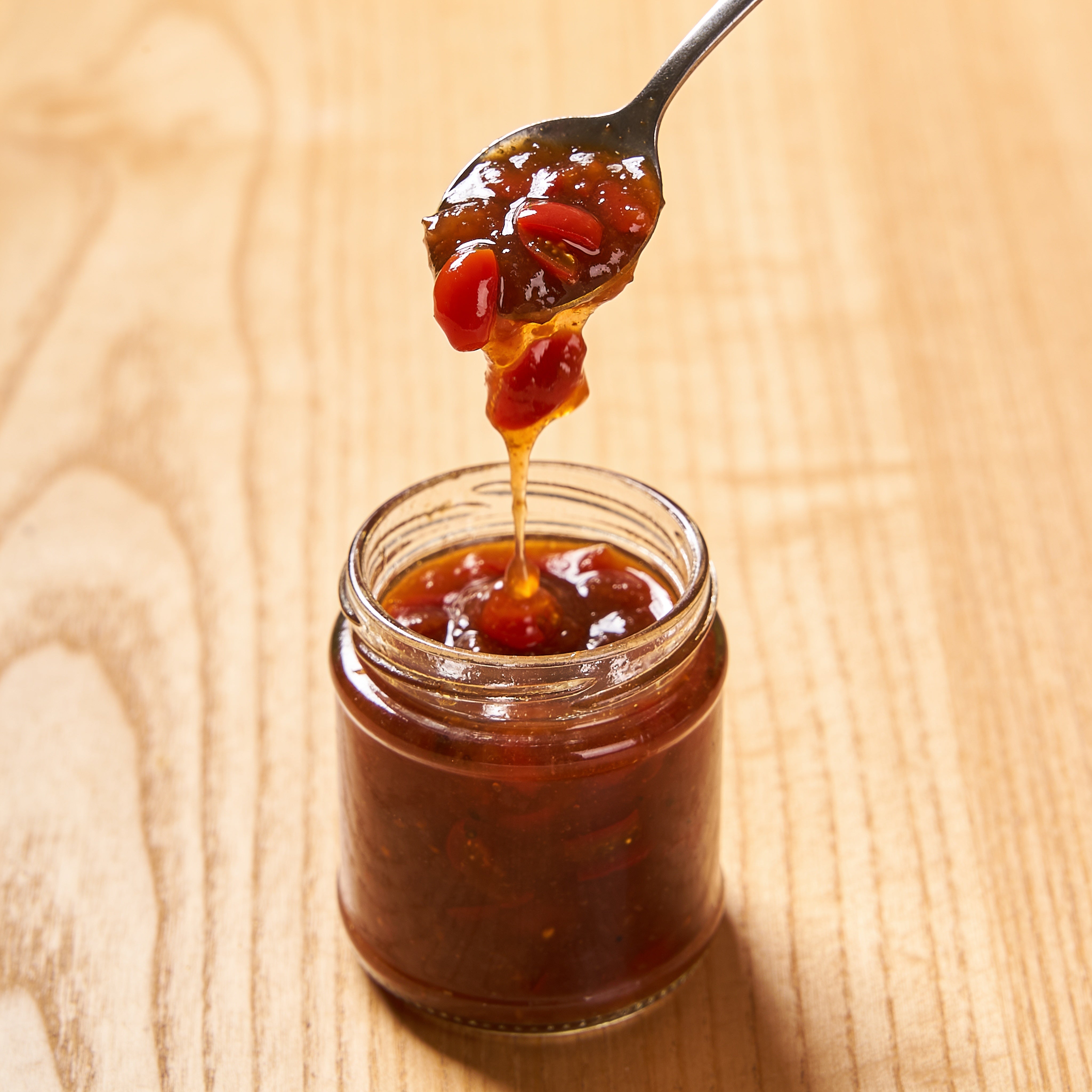 Tamco Tamarillo Relish being spooned, in action