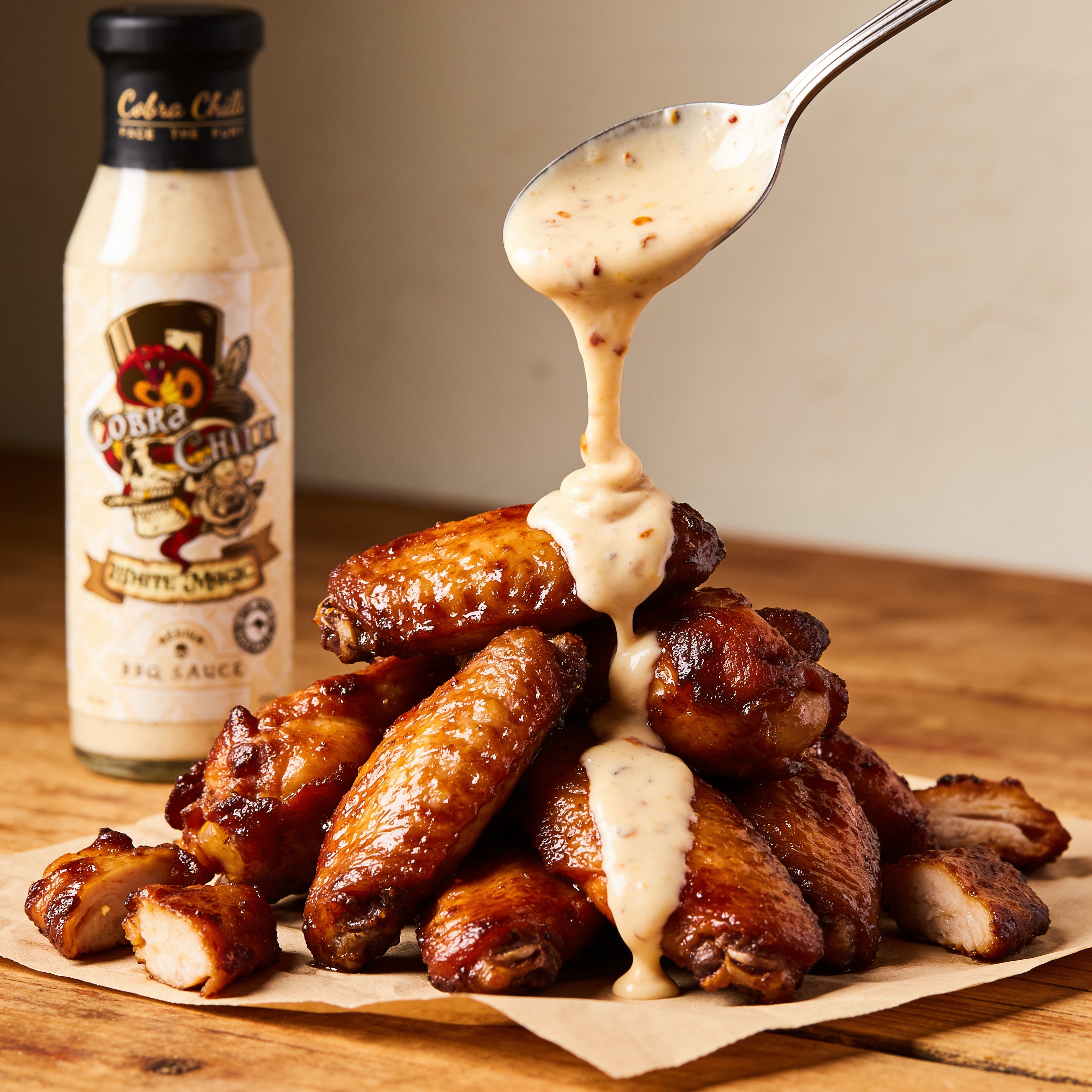 Cobra Chilli White Magic BBQ Sauce Medium 250ml BBQ Sauce — BBQ sauce drizzled over smoked chicken wings