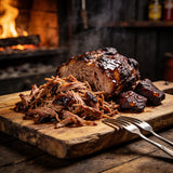Shredded pulled pork with a sticky caramelised bark on a wooden board