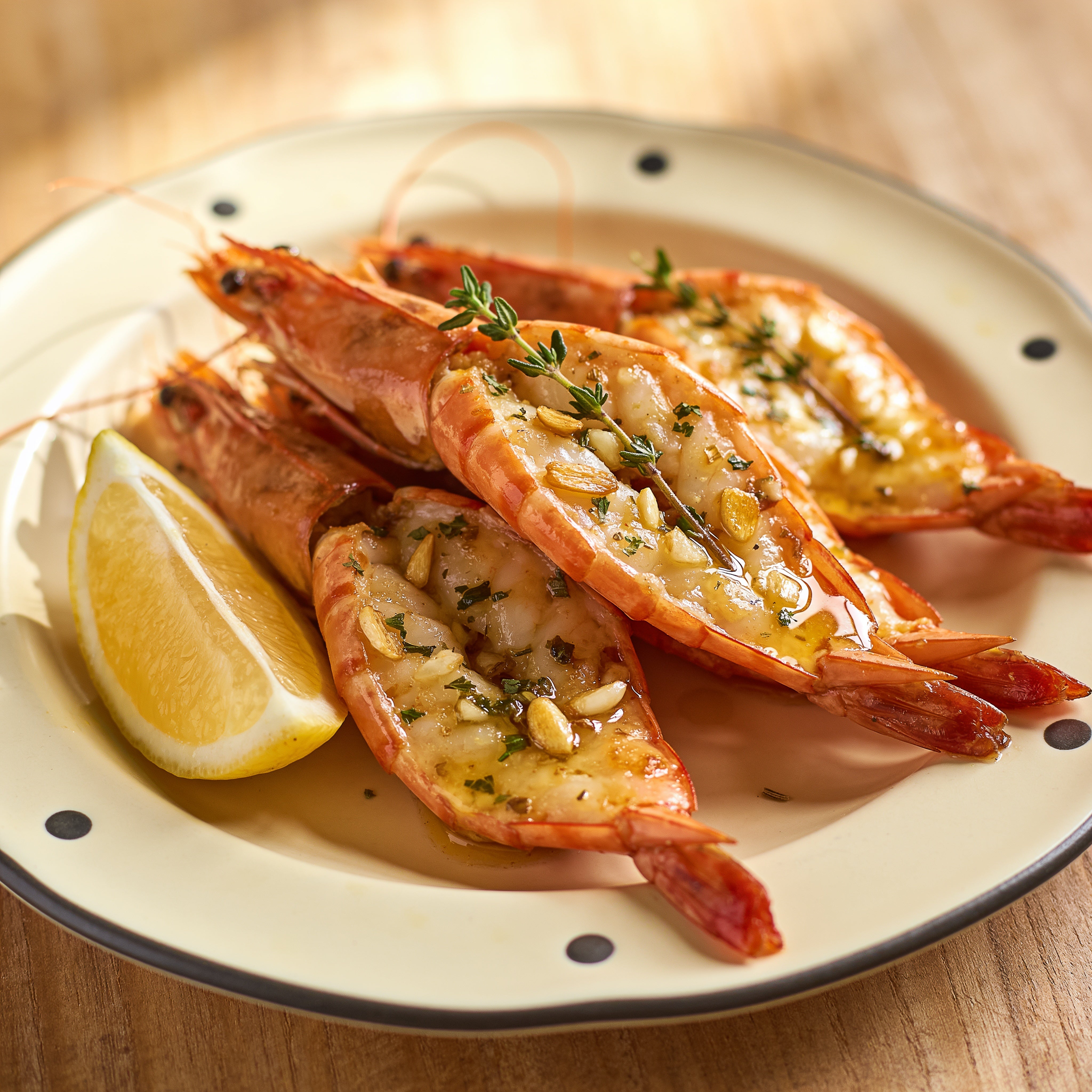 Outlaw Barbecue Gold Rush 280g garlic butter BBQ rub — split king prawns glistening with garlic butter and thyme