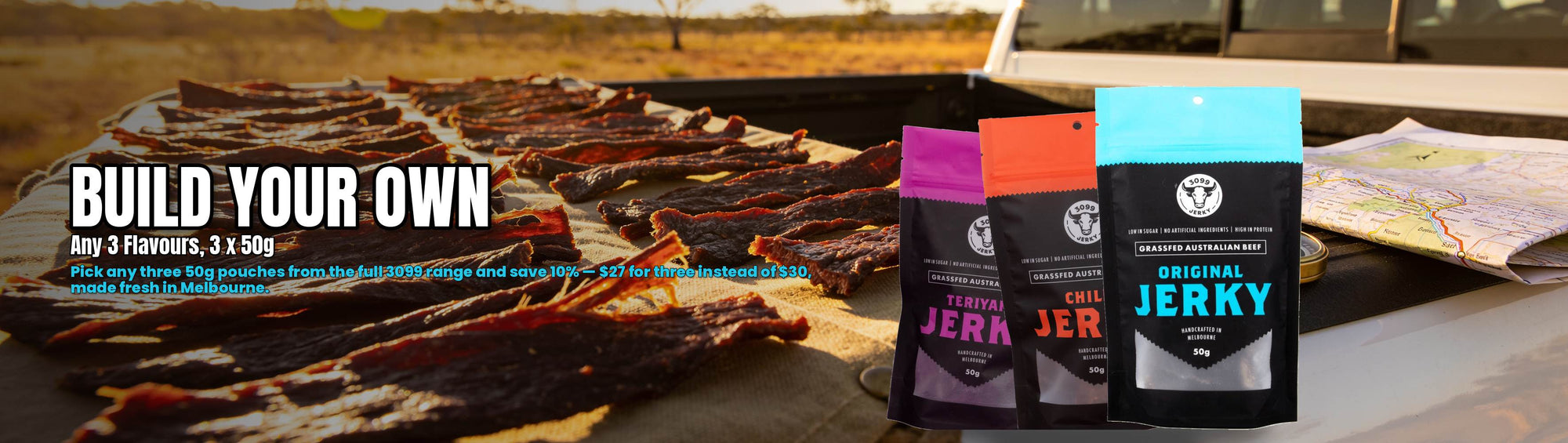 3099 Jerky Build-Your-Own 3-Pack — assorted beef jerky pouches on a ute tailgate road trip scene
