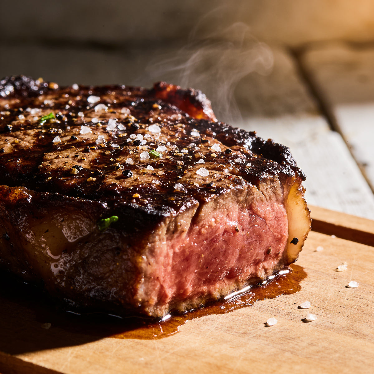 Macro glisten shot of a seared steak crust with salt and pepper