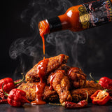 Reapers Roulette hot sauce drizzled over a pile of hot chicken wings