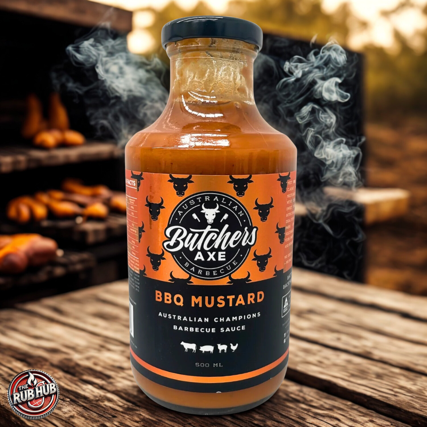 Butchers Axe BBQ Mustard Sauce 500 ml bottle front on a wooden surface with smoke in the background