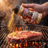 Cocaine Cowboy rub being shaken onto a steak on the grill
