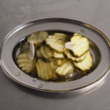 ACIDE Dill Cucumber Chips crinkle-cut dill pickles served on a board