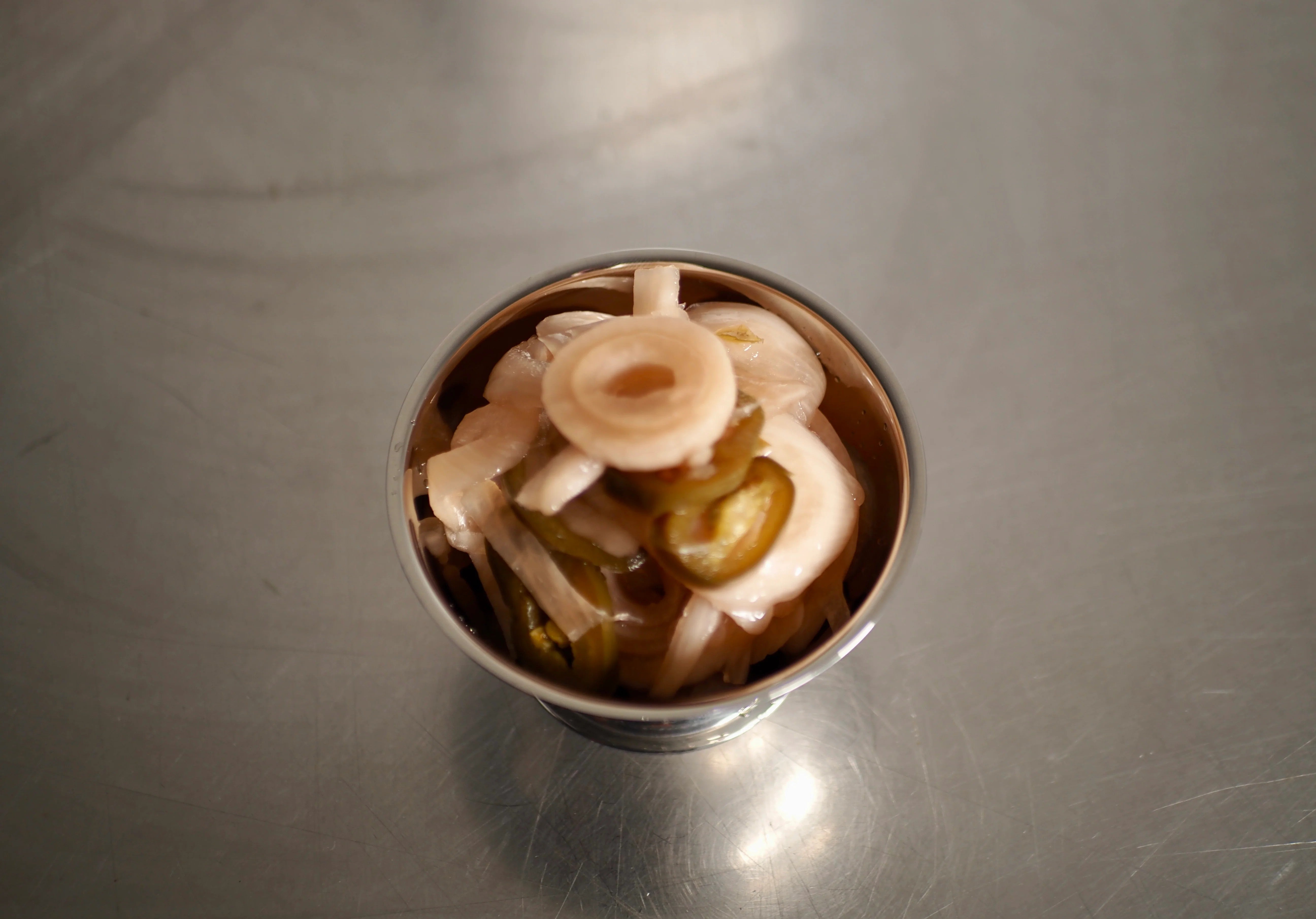 ACIDE Jalapeño Onions pickled hot-pink red onions served in a dish