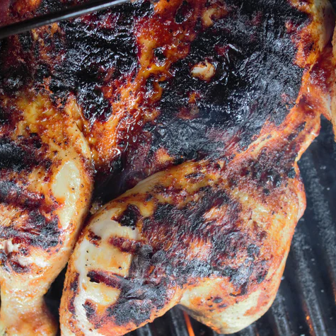 Alabama-style grilled chicken fresh off the grill