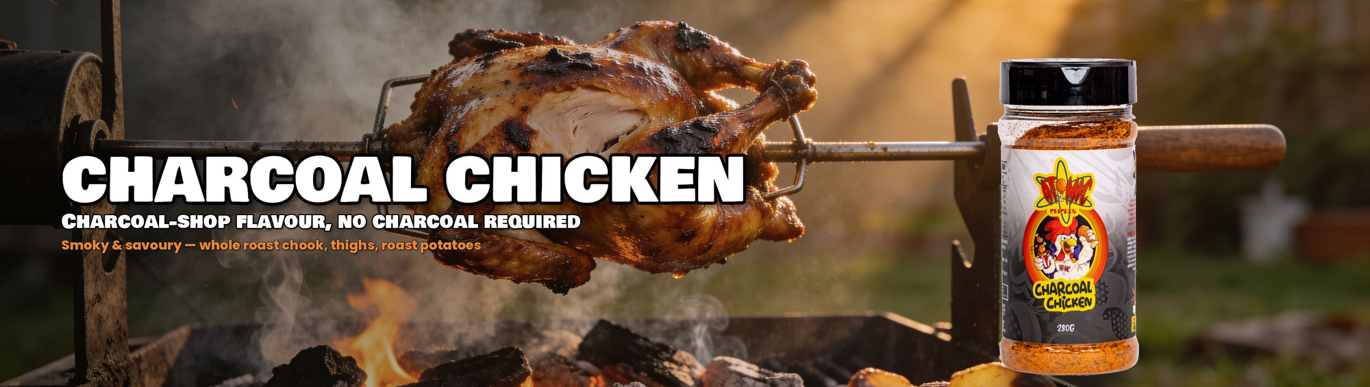 Atomic Chicken Charcoal Chicken Seasoning Rub with whole rotisserie chicken over glowing coals