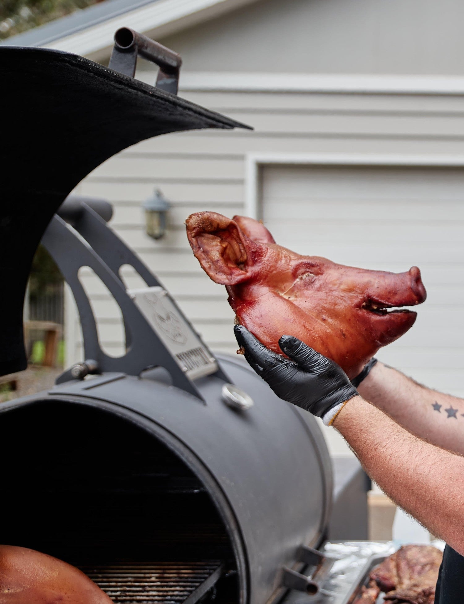 Barbecue Like a Boss by Adam Roberts hardback cookbook — author Adam Roberts at his smoker