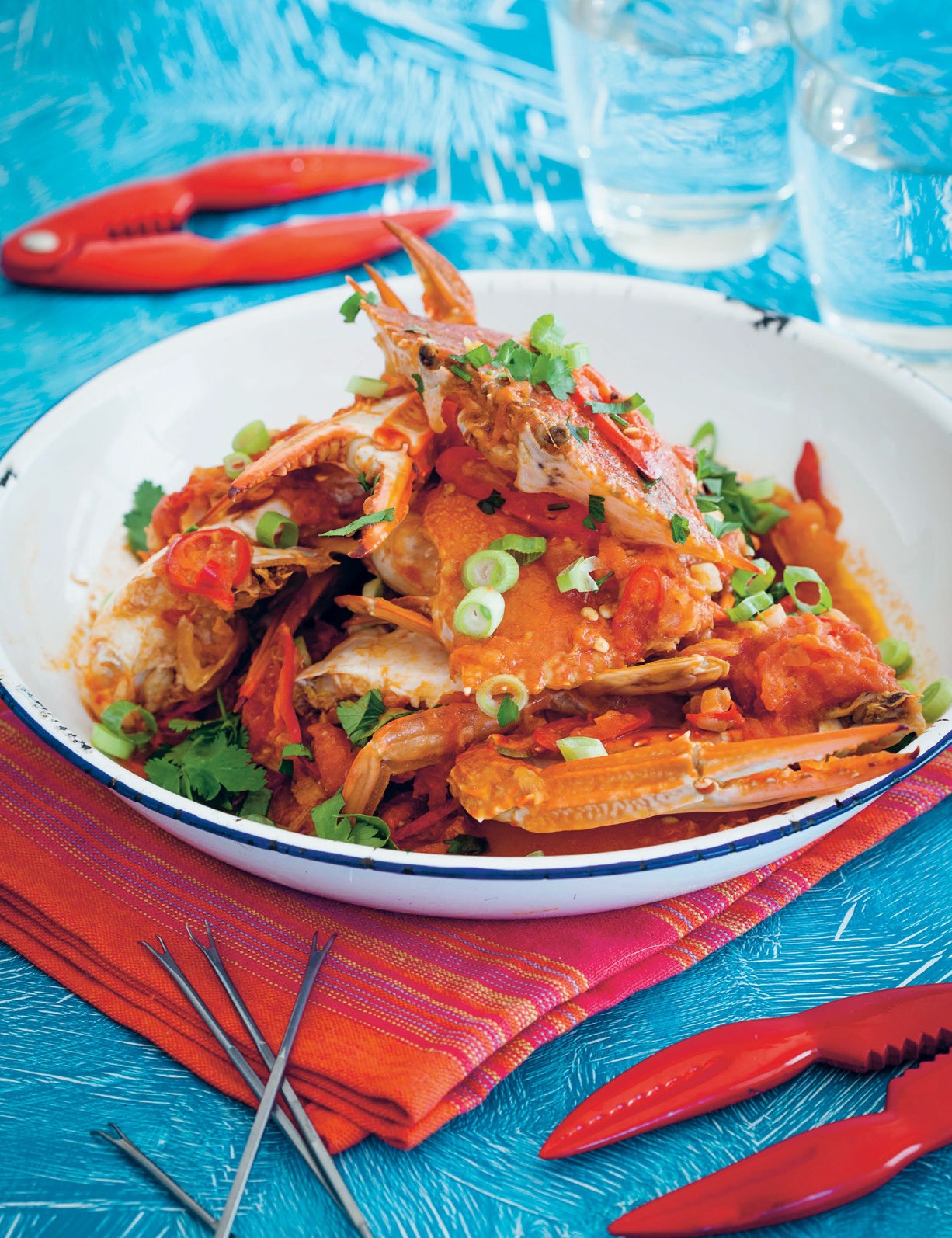 BBQ Companion by Ben O'Donoghue hardback cookbook — drunken crabs served on a bright blue table