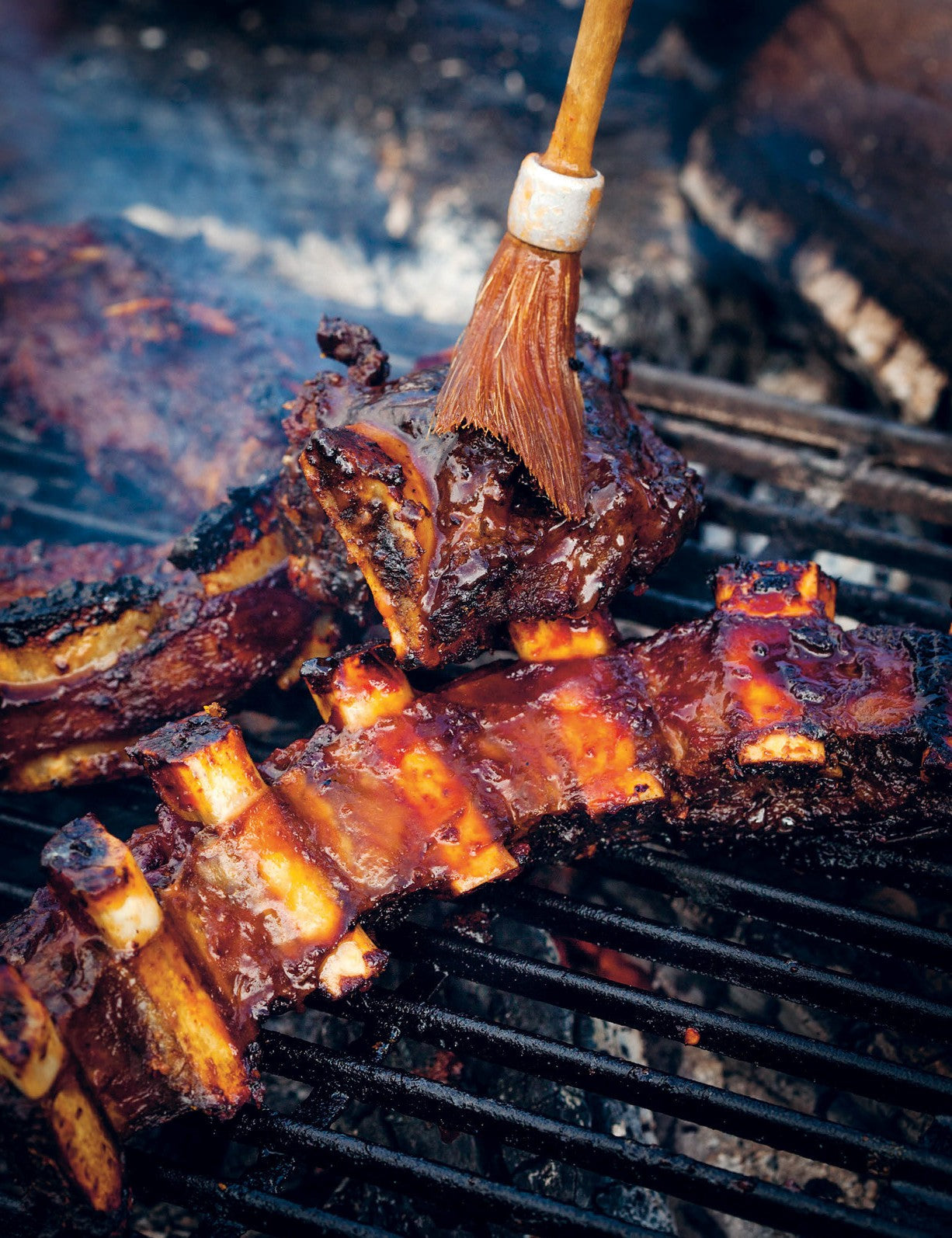 BBQ Companion by Ben O'Donoghue hardback cookbook — smoked beef short ribs with nam prik pla being basted